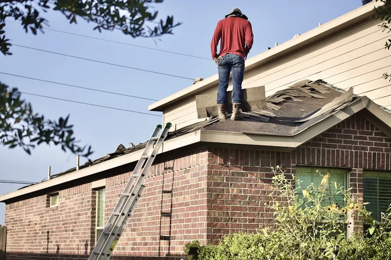 Professional roofer working on a residential roof in Latin Quarter